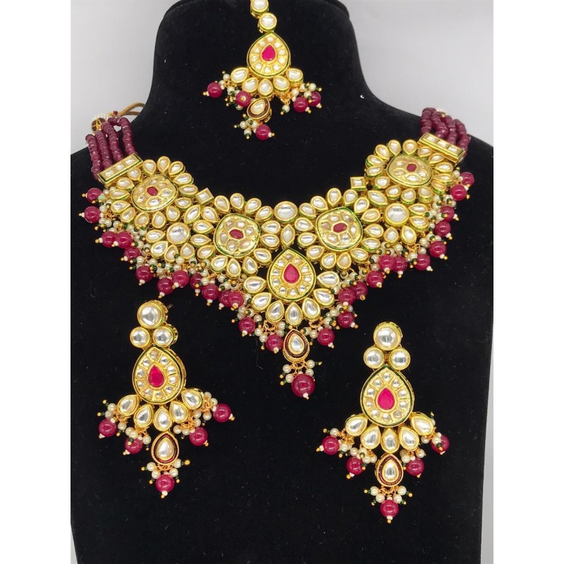 Shastta trendz Red and Gold Brass Kundan necklace set in ruby
